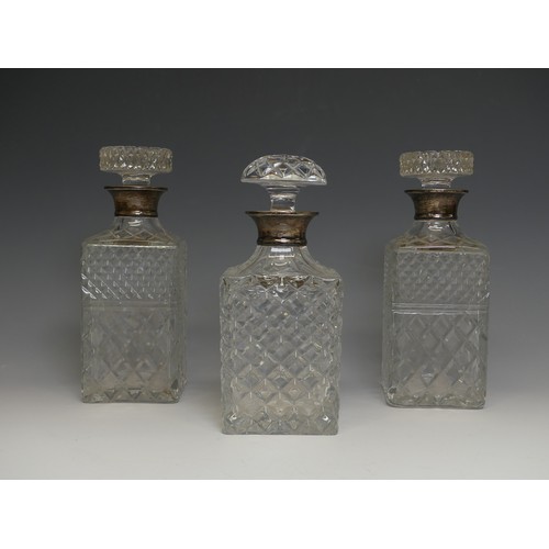 162 - A pair of silver-collared cut glass Decanters, by C J Vander, hallmarked London, 1969, together with... 