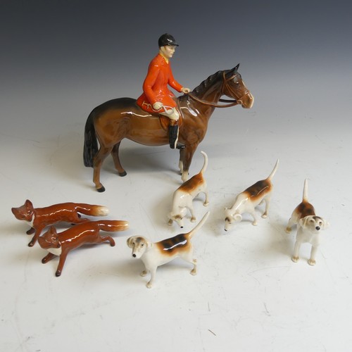 176 - A Beswick pottery figure of a Huntsman, together with with four hounds and two foxes and a large Bes... 