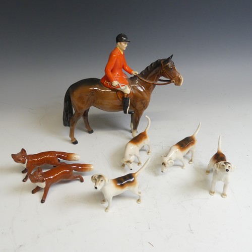 176 - A Beswick pottery figure of a Huntsman, together with with four hounds and two foxes and a large Bes... 