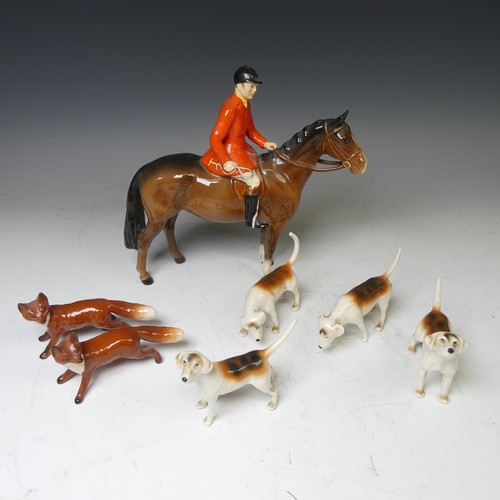 176 - A Beswick pottery figure of a Huntsman, together with with four hounds and two foxes and a large Bes... 