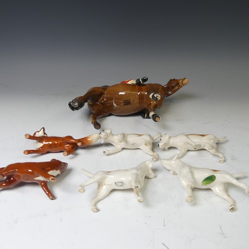 176 - A Beswick pottery figure of a Huntsman, together with with four hounds and two foxes and a large Bes... 