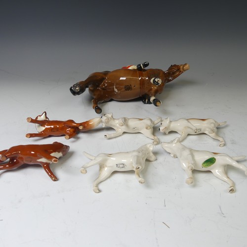 176 - A Beswick pottery figure of a Huntsman, together with with four hounds and two foxes and a large Bes... 