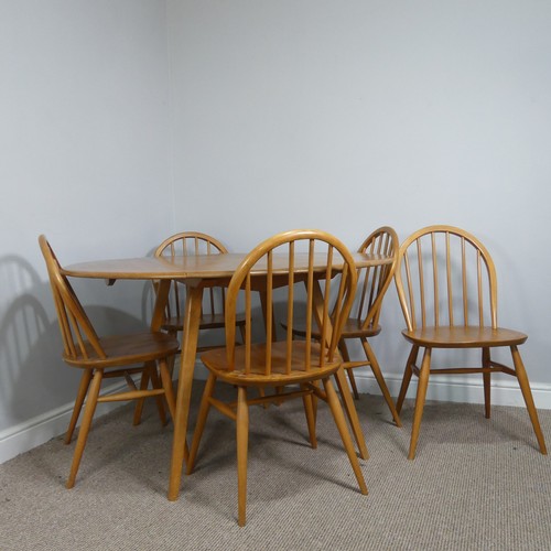 A 1960s Ercol blond elm drop-leaf Table, having oval fall leaves and raised on slightly tapering supports together with five stickback Chairs, each on turned legs with high 'H' stretchers, (table) W 121 cmc x H 71 cm x  D 102.5 cm, (chair) W 49 cm x H 81 cm x D 42 cm(6)