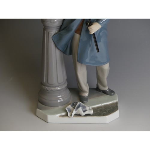 207 - A Lladro porcelain model of a Lamplighter, modelled with figure holding a torch toward the lamp, H 4... 