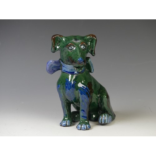 171 - An early 20thC C. H. Brannam glazed figure of a Dog, of green ground, modelled with collar and spots... 