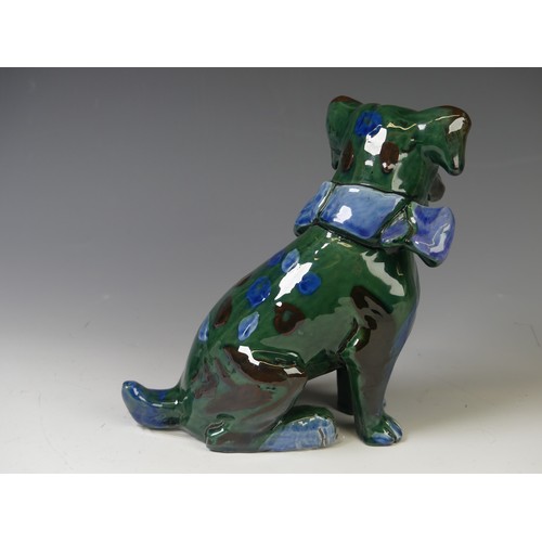 171 - An early 20thC C. H. Brannam glazed figure of a Dog, of green ground, modelled with collar and spots... 