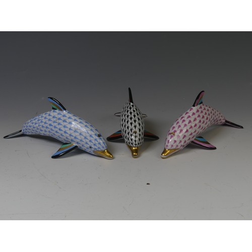 202 - A trio of Herend Hungarian porcelain Dolphins, in pink, blue and black, each with factory marks to b... 