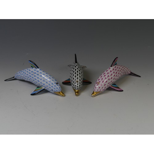 202 - A trio of Herend Hungarian porcelain Dolphins, in pink, blue and black, each with factory marks to b... 