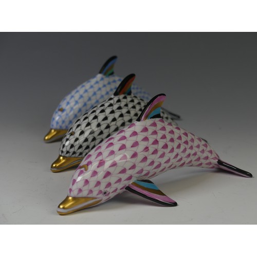 202 - A trio of Herend Hungarian porcelain Dolphins, in pink, blue and black, each with factory marks to b... 