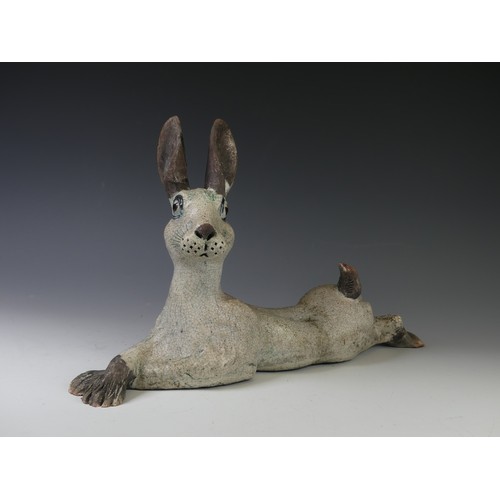 136 - A studio pottery raku Hare, in the style of Lawson Rudge, modelled in recumbent pose with crossed fr... 