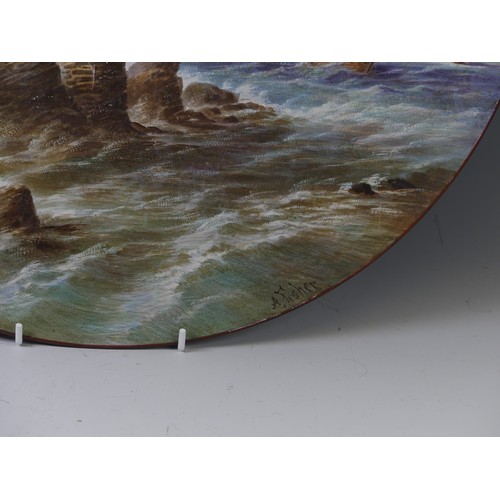 147 - A late 19thC enamelled and painted Charger, depicting a lighthouse before stormy seas, signed A Fish... 