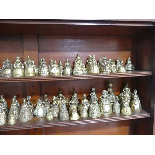 A collection of approximately one hundred antique brass crinoline 'Lady  Bells', sand cast, various p