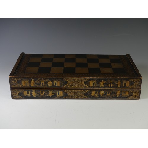 257 - An early 19thC Chinese export lacquer rectangular games box, decorated in gilt with a chess board, t... 