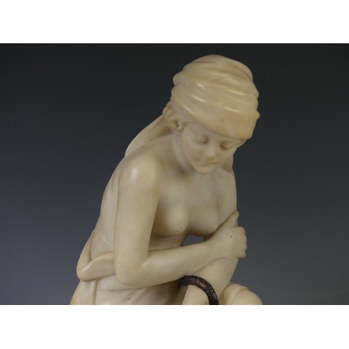 266 - An alabaster sculpture of Cleopatra, modelled half nude, kneeling and with a brown snake coiled arou... 