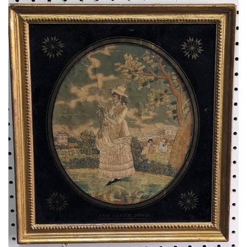 290 - A Georgian embroidered portrait of a Woman, in oval eglomise frame, titled and dated 'Ann Cluer 1800... 