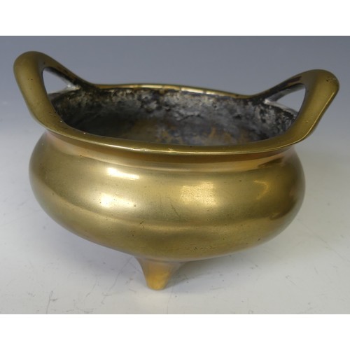 217 - A Chinese gilt bronze Tripod Censer, of typical circular form with two loop handles, raised on three... 