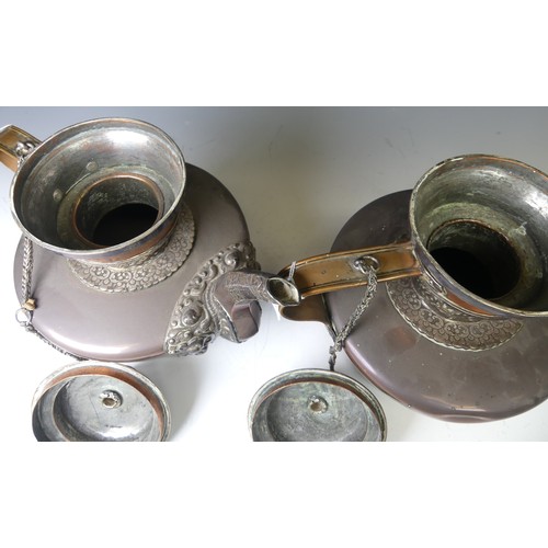 221 - A pair of 19thC Tibetan silver mounted copper ceremonial Teapots, of typical form, the removable dom... 