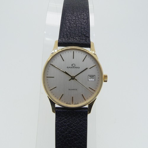 284 - A 9ct yellow gold Garrard quartz Wristwatch, the reverse with presentation inscription dated 1990, 3... 