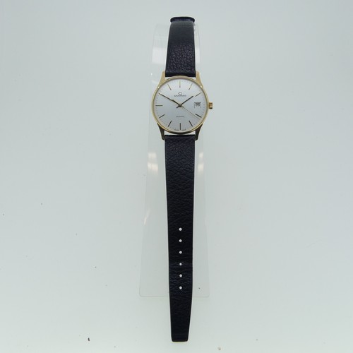 284 - A 9ct yellow gold Garrard quartz Wristwatch, the reverse with presentation inscription dated 1990, 3... 