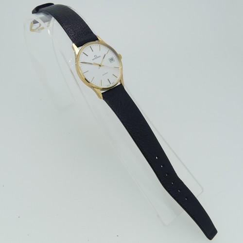 284 - A 9ct yellow gold Garrard quartz Wristwatch, the reverse with presentation inscription dated 1990, 3... 