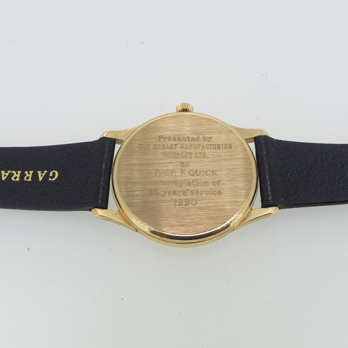 284 - A 9ct yellow gold Garrard quartz Wristwatch, the reverse with presentation inscription dated 1990, 3... 