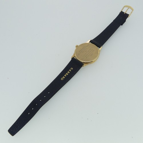 284 - A 9ct yellow gold Garrard quartz Wristwatch, the reverse with presentation inscription dated 1990, 3... 