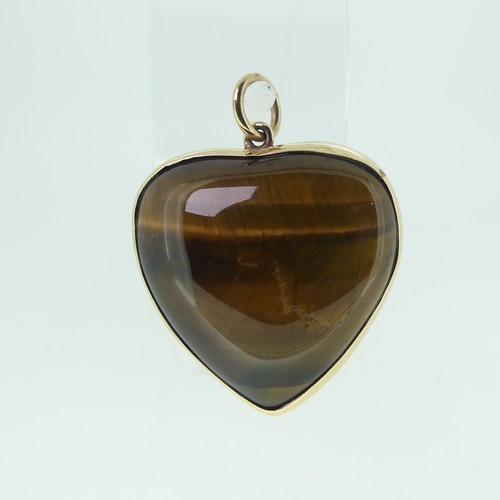 221 - A 9ct gold mounted Tiger's Eye heart shaped Pendant, hallmarked London 1977, 3cm wide.... 