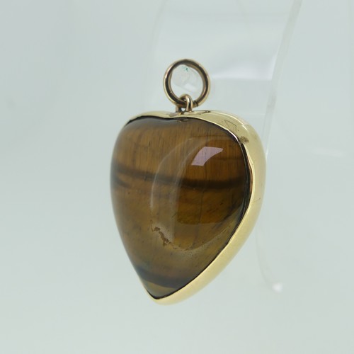 221 - A 9ct gold mounted Tiger's Eye heart shaped Pendant, hallmarked London 1977, 3cm wide.... 