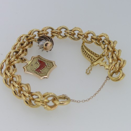 178 - An 18ct gold fancy link Bracelet, with three gold charms suspended, including a 14ct Taurus plaque, ... 