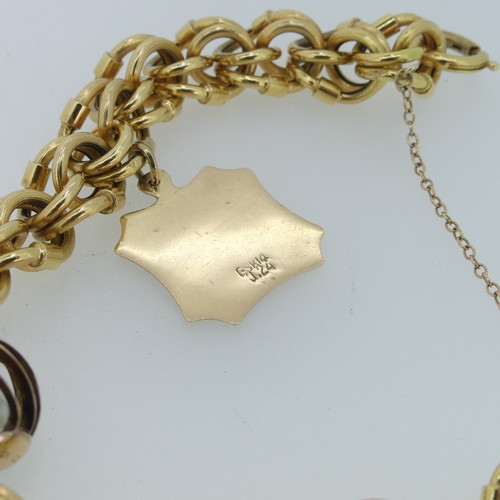 178 - An 18ct gold fancy link Bracelet, with three gold charms suspended, including a 14ct Taurus plaque, ... 