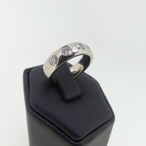 98 - An 18ct white gold Band, set with five diamonds, each approx 0.2ct, the band 5.6mm wide, Size L½, 12... 