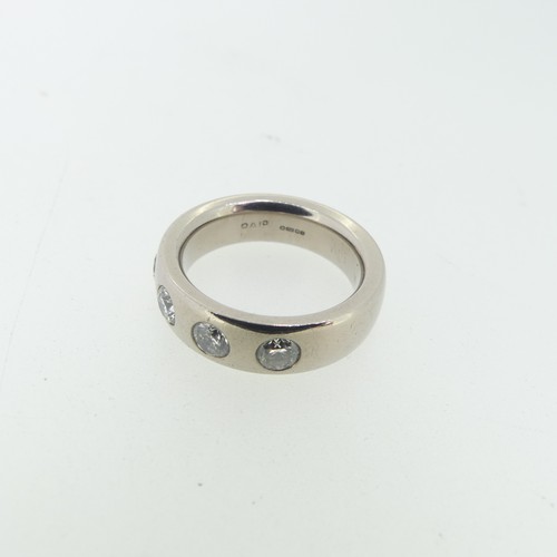 98 - An 18ct white gold Band, set with five diamonds, each approx 0.2ct, the band 5.6mm wide, Size L½, 12... 