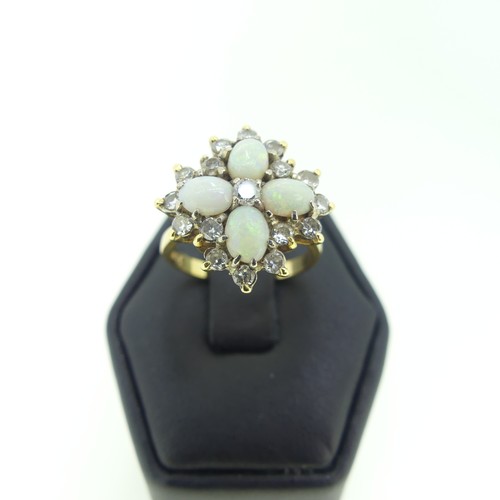 99 - An opal and diamond cocktail Ring, with four oval cabochon opals, each 5.5mm long, set in a cross wi... 