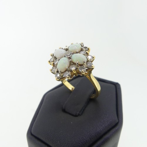 99 - An opal and diamond cocktail Ring, with four oval cabochon opals, each 5.5mm long, set in a cross wi... 