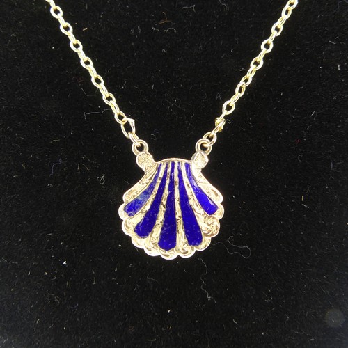 102 - An antique scallop shell memorial Pendant, the front with five rays of blue enamel, the reverse with... 