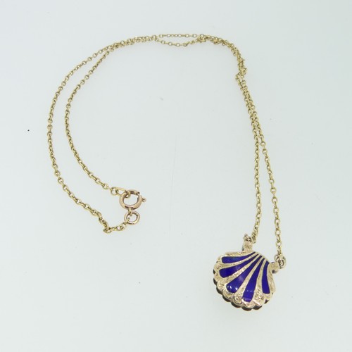 102 - An antique scallop shell memorial Pendant, the front with five rays of blue enamel, the reverse with... 