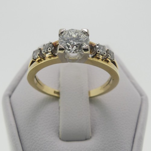 105 - A 14ct gold and diamond Ring, the central brilliant cut stone approx. 0.65ct, four claw set in white... 