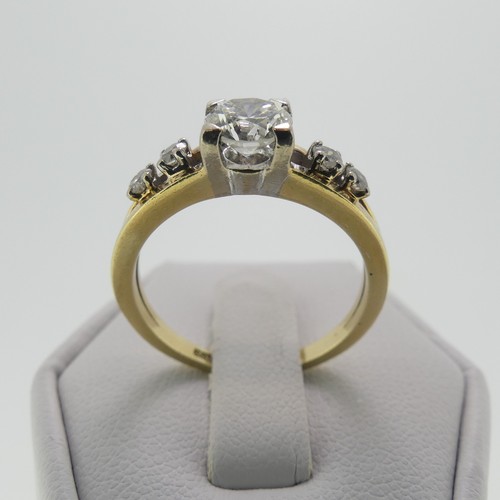 105 - A 14ct gold and diamond Ring, the central brilliant cut stone approx. 0.65ct, four claw set in white... 