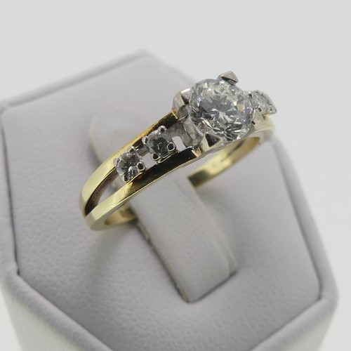 105 - A 14ct gold and diamond Ring, the central brilliant cut stone approx. 0.65ct, four claw set in white... 