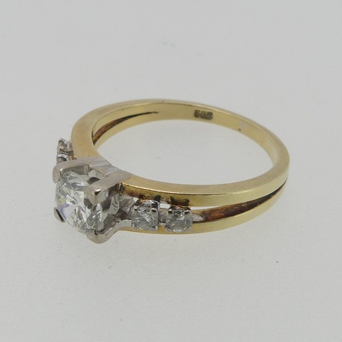 105 - A 14ct gold and diamond Ring, the central brilliant cut stone approx. 0.65ct, four claw set in white... 