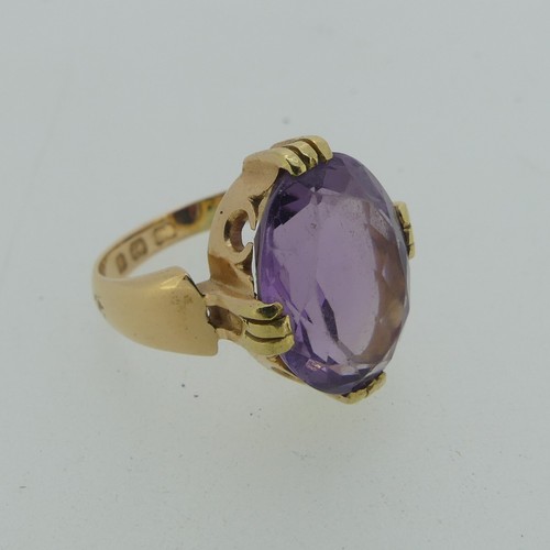 106 - An amethyst Dress Ring, the oval facetted stone 15mm long, mounted in 18ct yellow gold, Size M, 7.7g... 