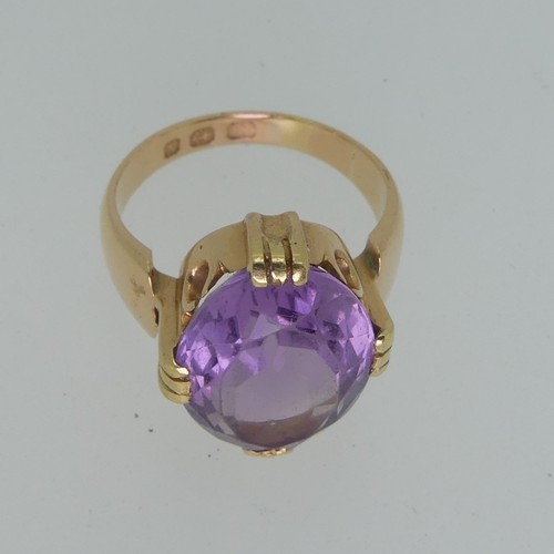 106 - An amethyst Dress Ring, the oval facetted stone 15mm long, mounted in 18ct yellow gold, Size M, 7.7g... 