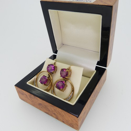 196 - A pair of synthetic pink sapphire Earrings, the 9ct gold open circular drops with claw set sapphire ... 