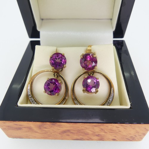 196 - A pair of synthetic pink sapphire Earrings, the 9ct gold open circular drops with claw set sapphire ... 