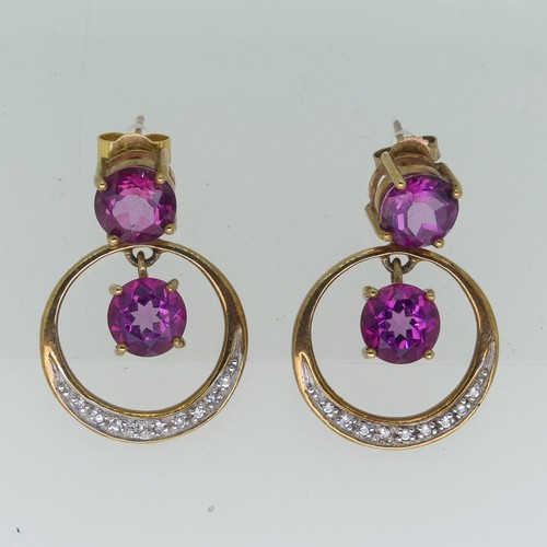 196 - A pair of synthetic pink sapphire Earrings, the 9ct gold open circular drops with claw set sapphire ... 