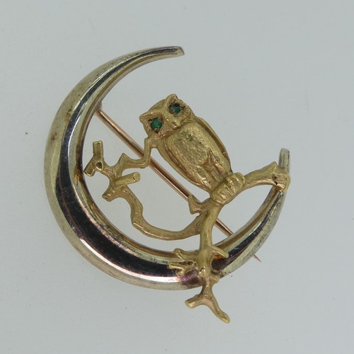 197 - A 9ct yellow gold Owl Brooch, naturalistically modelled on a branch with emerald eyes, within a poli... 