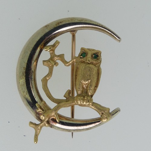 197 - A 9ct yellow gold Owl Brooch, naturalistically modelled on a branch with emerald eyes, within a poli... 