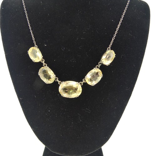 151 - A vintage graduated five stone citrine Necklace, the oval facetted stones claw set on integral silve... 