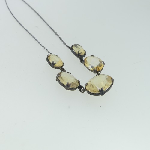 151 - A vintage graduated five stone citrine Necklace, the oval facetted stones claw set on integral silve... 