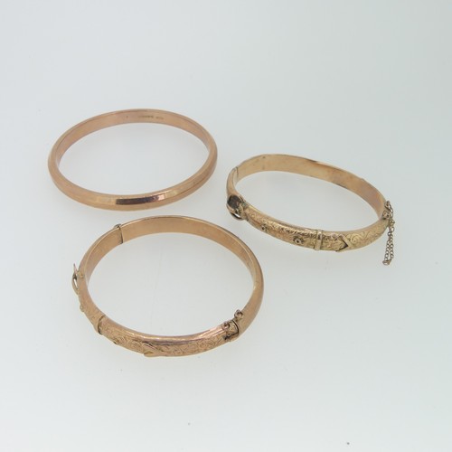 230 - Two 9ct rose gold hollow hinged Buckle Bangles, as found, together with a plain 9ct rose gold hollow... 